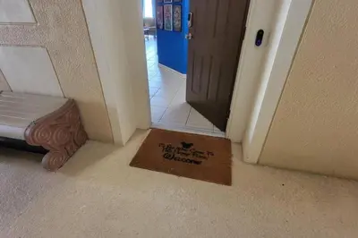 a welcome mat in front of a door in a hallway at C7671-402 Windsor Hills Resort 2Bedrm Themed Condo in Orlando