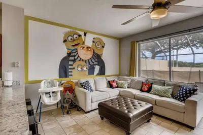 a living room with a couch and a large painting at T7673F Windsor Hills Resort 3Bed POOL Pet Friendly in Orlando