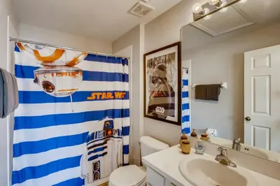 a bathroom with a blue and white shower curtain and a sink at T7674O Windsor Hills Resort 3Bedrm 2miles Disney in Orlando