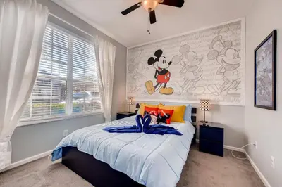 a bedroom with a mickey mouse mural on the wall at T2367 Windsor Palm Resort Pool 3 miles to Disney in Kissimmee
