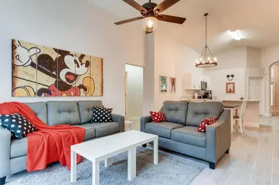 a living room with two couches and a table at H8438S Emerald Island Resort One Level POOL Pet OK in Kissimmee