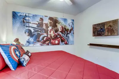 a bedroom with a superhero poster on the wall at H8438S Emerald Island Resort One Level POOL Pet OK in Kissimmee