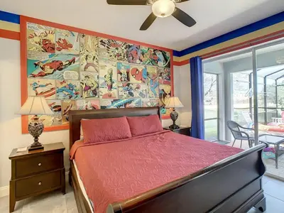 a bedroom with a bed and a painting on the wall at H2713M Windsor Hills Resort 4Bedrm POOL SPA Disney in Orlando