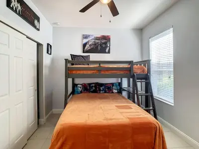 a bedroom with two bunk beds and a ceiling fan at H2713M Windsor Hills Resort 4Bedrm POOL SPA Disney in Orlando