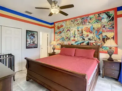 a bedroom with a bed and a painting on the wall at H2713M Windsor Hills Resort 4Bedrm POOL SPA Disney in Orlando