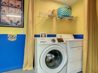 a washer and dryer in a laundry room at H8536 Single Level Pool Spa Home 5 Bed Near Disney in Kissimmee