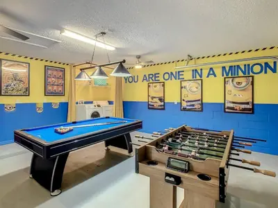 a ping pong table in a room with a bill at H8536 Single Level Pool Spa Home 5 Bed Near Disney in Kissimmee