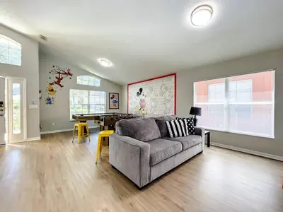 a living room with a couch and a table at H2631E Resort Single Level POOL SPA Home Disney in Kissimmee