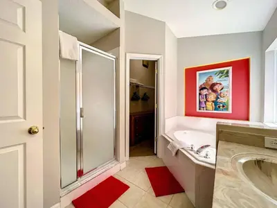 a bathroom with a shower and a bath tub at H2631E Resort Single Level POOL SPA Home Disney in Kissimmee