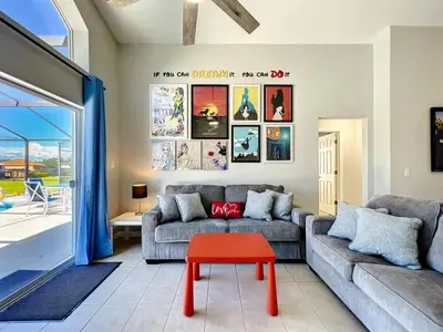 a living room with a couch and a red stool at H2631E Resort Single Level POOL SPA Home Disney in Kissimmee