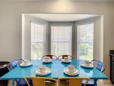 a blue table with chairs and cups and saucers at H2553O Single Level 5 Bedrm Pool 3Miles Disney in Kissimmee