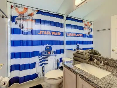 a bathroom with a star wars shower curtain and a toilet at H2553O Single Level 5 Bedrm Pool 3Miles Disney in Kissimmee