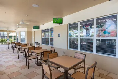 a dining room with tables and chairs and televisions at C2788-105 Windsor Hills Resort 3Bedrm Themed Condo Water Park in Orlando