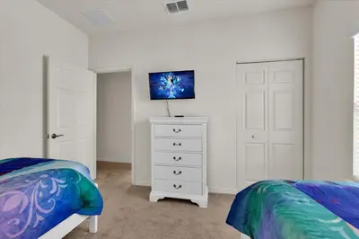 a bedroom with two beds and a white dresser at 3206 Gold in Kissimmee