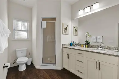 a bathroom with a toilet and a sink and a shower at 3206 Gold in Kissimmee