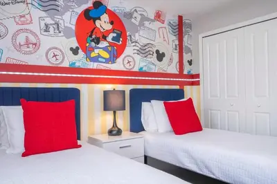 a bedroom with two beds with red pillows at Charming 4Bd w Private Pool @ Storey Lake Resort 2653 in Kissimmee