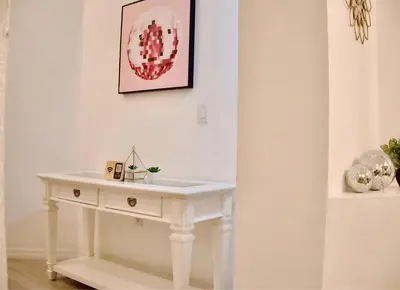 a white table in a room with a picture on the wall at Disney World Getaway: 4 Br - Sunroof - BBQ Bliss in Orlando