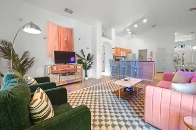 a living room with two couches and a tv at Disney World Getaway: 4 Br - Sunroof - BBQ Bliss in Orlando