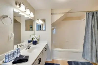 a white bathroom with a sink and a shower at Haven Beautiful 3 BR TH in Gated Resort Community in Kissimmee