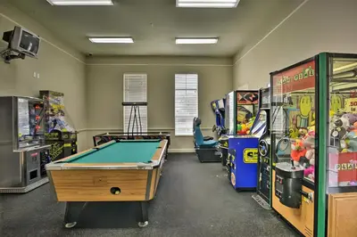 a room with a pool table and arcade games at Haven Beautiful 3 BR TH in Gated Resort Community in Kissimmee