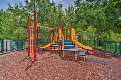 a playground with a slide in a park at Haven Beautiful 3 BR TH in Gated Resort Community in Kissimmee