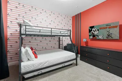 a bedroom with a bunk bed and a red wall at New Home 5 Bedrooms and 4 Bathrooms At Storey Lake in Kissimmee
