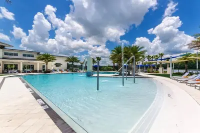 a swimming pool at a resort with palm trees at Amazing 5Bedrooms4.5Baths- Nexto to Disney in Kissimmee