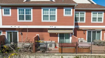 a orange house with a fence in front of it at Awesome 4 Suites Villa 5 Min to Disney in Orlando