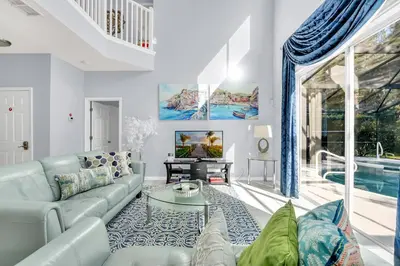 a living room with a couch and a table at 8462 Secret Key Cove in Kissimmee