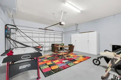 a room with a desk and a table on a rug at 8462 Secret Key Cove in Kissimmee