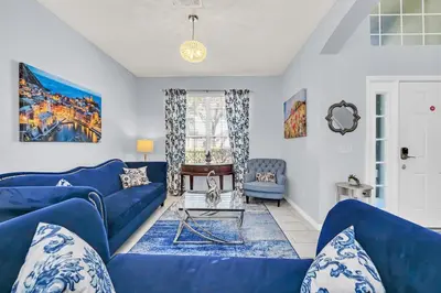 a living room with blue couches and a table at 8462 Secret Key Cove in Kissimmee