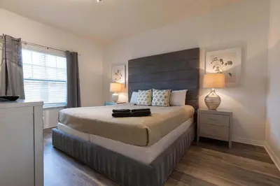 a bedroom with a large bed and a window at Fabulous townhome near the Parks in Kissimmee