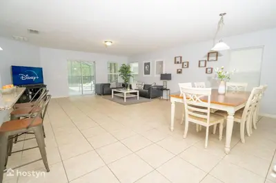 a dining room and living room with a table and chairs at Beautiful vacation home near Disney in Kissimmee