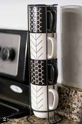 a black and white mug sitting next to a microwave at Beautiful vacation home near Disney in Kissimmee