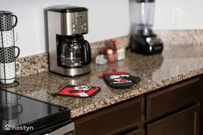 a kitchen counter with a coffee maker on a counter top at Beautiful vacation home near Disney in Kissimmee