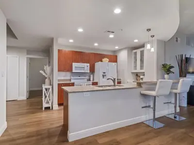 a kitchen with white cabinets and a large island at 4Bedroom/ 2bath 2100sq ft Thorton Park Master Suite in Orlando