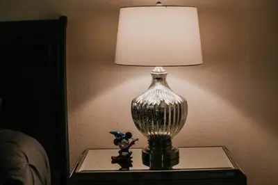 a lamp sitting on a table next to a bed at Family house with amazing themed rooms in Kissimmee