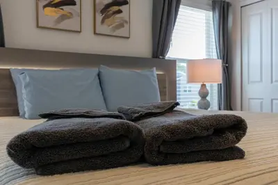 a pile of towels sitting on top of a bed at Amazing house near the parks in Kissimmee