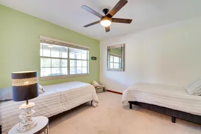 a bedroom with two beds and a ceiling fan at 1-Acre Backyard and Gym Spacious Apopka Escape! in Orlando