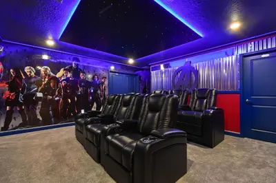 a cinema room with black chairs and purple lights at 5 Star Exceptional Luxury Villa at Storey Lake mins to Disney in Kissimmee