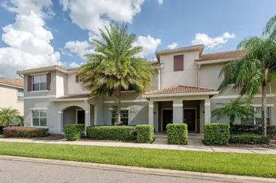 a house with palm trees in front of it at 9 min to Disney w Pool- 4BD 3BA - FREE Waterpark in Kissimmee