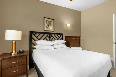 a bedroom with a large bed with white pillows at Summer Stay - Renovated TownHome by Disney! in Orlando