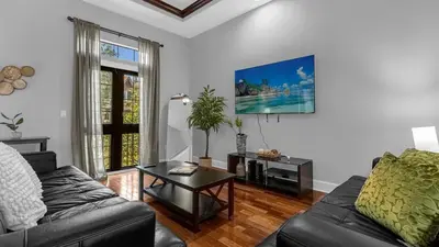 a living room with a couch and a table at Sun, Fun & Summer Getaway - TownHome by Disney! in Orlando