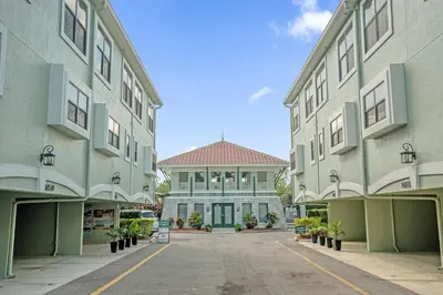 an empty parking lot in front of two buildings at Sun, Fun & Summer Getaway - TownHome by Disney! in Orlando