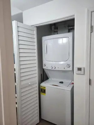 a small television sitting on top of a refrigerator at Orlando 3rd Floor - Blue Heron in Orlando