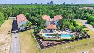 an aerial view of a resort with a swimming pool at Cozy & Elegant 4BR Enchanted Townhouse - 1 Mile to Disney with Resort Pool, Gym, & Jacuzzi in Orlando