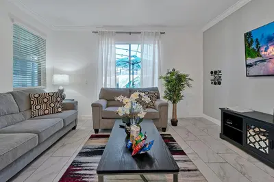 a living room with a couch and a coffee table at Storey Lake Escape w/ Pool, Games & Water Park in Kissimmee