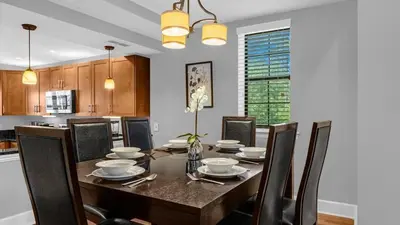 a dining room with a wooden table and chairs at Florida Getaway - Renovated TownHome by Disney! in Orlando