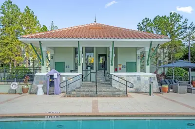 a house with a pool in front of it at Florida Getaway - Renovated TownHome by Disney! in Orlando