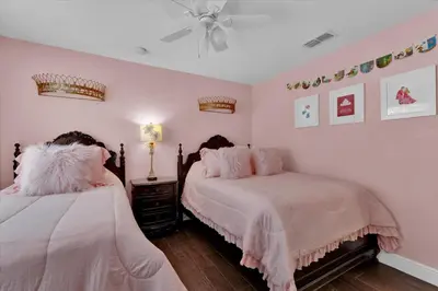 a bedroom with two beds with pink walls at 7752 Tosteth in Kissimmee